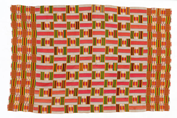Woven textile with a geometric pattern in red, orange, and green on a white background